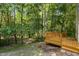 Home's back deck is surrounded by thick, green trees at 6604 Frogstool Ln, Raleigh, NC 27610