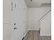 Entryway features wood look floors, a white door, and stairs leading up to the second floor at 6604 Frogstool Ln, Raleigh, NC 27610