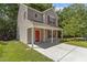 Charming two-story home with red door and shutters and landscaped front yard at 6604 Frogstool Ln, Raleigh, NC 27610