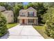 Charming two-story home with red door and shutters and long driveway at 6604 Frogstool Ln, Raleigh, NC 27610