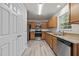 Galley kitchen with stainless steel appliances, granite countertops, and oak cabinets at 6604 Frogstool Ln, Raleigh, NC 27610