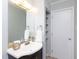 Cozy bathroom with dark vanity, white sink, and ample storage at 7353 Sandy Creek Dr, Raleigh, NC 27614