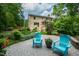 Paver patio area in backyard with lawn furniture, with partial view of house and screened in porch at 776 Legend Oaks Dr, Chapel Hill, NC 27517
