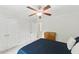 The bedroom is complemented by ample natural light, a cozy blue bed set, and plenty of storage with double doors at 776 Legend Oaks Dr, Chapel Hill, NC 27517