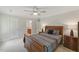 Warm bedroom features a spacious bed set with wood accents, offering a peek into the connected bathroom at 776 Legend Oaks Dr, Chapel Hill, NC 27517