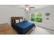 This bedroom features a plush blue bed set and a large window showcasing the natural greenery outdoors at 776 Legend Oaks Dr, Chapel Hill, NC 27517