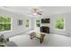 Bright bonus room with plush carpet, ceiling fan, and several windows offering views of the lush surrounding greenery at 776 Legend Oaks Dr, Chapel Hill, NC 27517