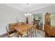 Spacious dining room featuring a large wooden table, elegant lighting, and views into the adjacent living spaces at 776 Legend Oaks Dr, Chapel Hill, NC 27517