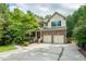 Charming home featuring a covered porch, brick accents, and a two-car garage at 776 Legend Oaks Dr, Chapel Hill, NC 27517