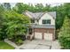 Beautiful two-story brick home with a manicured lawn, two-car garage, and charming front porch in a wooded setting at 776 Legend Oaks Dr, Chapel Hill, NC 27517