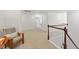 Upstairs hallway features neutral carpet, wood railing, and an accent chair at 776 Legend Oaks Dr, Chapel Hill, NC 27517