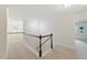 Bright upstairs hallway features neutral carpeting and a classic white banister at 776 Legend Oaks Dr, Chapel Hill, NC 27517