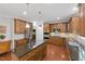 Spacious kitchen featuring wood cabinets, stainless steel appliances, granite countertops, and a kitchen island at 776 Legend Oaks Dr, Chapel Hill, NC 27517