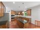 Well-lit kitchen with wood cabinets, stainless steel appliances, granite countertops, kitchen island and eat-in dining area at 776 Legend Oaks Dr, Chapel Hill, NC 27517