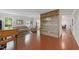 Open-concept living room with hardwood floors, decorative wood accent wall, and large windows for natural light at 776 Legend Oaks Dr, Chapel Hill, NC 27517