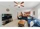 Open-concept living room with a blue sofa, view into kitchen and hardwood floors at 776 Legend Oaks Dr, Chapel Hill, NC 27517