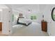 Spacious main bedroom featuring tray ceilings, plush carpeting, and ample natural light at 776 Legend Oaks Dr, Chapel Hill, NC 27517