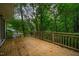 Spacious back deck offers an excellent view of the wooded scenery for serene outdoor living at 803 Churchill Dr, Chapel Hill, NC 27517