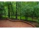 Brick patio with scenic wooded backyard, ideal for outdoor entertaining and relaxation at 803 Churchill Dr, Chapel Hill, NC 27517