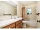 Bathroom with vanity, sink, toilet, and shower/tub at 803 Churchill Dr, Chapel Hill, NC 27517