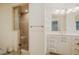 Elegant bathroom with a glass-enclosed shower, vanity with sink, and storage, exuding a clean, modern style at 803 Churchill Dr, Chapel Hill, NC 27517
