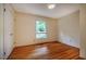 A bedroom featuring hardwood floors and bright window at 803 Churchill Dr, Chapel Hill, NC 27517