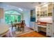 Sunlit dining area boasts a large window, skylight, and a built-in hutch for a perfect dining experience at 803 Churchill Dr, Chapel Hill, NC 27517