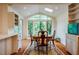 Bright dining area with large windows and skylights, complete with a rustic dining table and seating for Gathering gatherings at 803 Churchill Dr, Chapel Hill, NC 27517