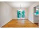 Bright dining area with hardwood floors and a sliding glass door to the outside balcony at 803 Churchill Dr, Chapel Hill, NC 27517