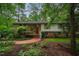 Charming two-story home with brick accents, complemented by a red front door and lush landscaping at 803 Churchill Dr, Chapel Hill, NC 27517