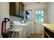 Functional laundry area with full-size washer and dryer, plus storage at 803 Churchill Dr, Chapel Hill, NC 27517