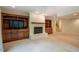 Spacious carpeted living room with built-in shelves and a fireplace at 803 Churchill Dr, Chapel Hill, NC 27517