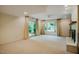 Large living room with carpet, crown molding, and large windows at 803 Churchill Dr, Chapel Hill, NC 27517