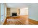 Spacious living room with hardwood floors, fireplace, built-in shelving, and abundant natural light from large windows at 803 Churchill Dr, Chapel Hill, NC 27517
