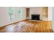 Bright living room featuring hardwood floors, a fireplace with built-ins, and large windows offering natural light at 803 Churchill Dr, Chapel Hill, NC 27517