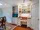 Cozy office area offers built-in shelves, cabinets, and a wooden desk for a functional workspace at 803 Churchill Dr, Chapel Hill, NC 27517