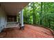 Covered brick patio features a porch swing and scenic views of the wooded yard at 803 Churchill Dr, Chapel Hill, NC 27517