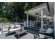 Inviting back deck with seating, dining, and lounge area, plus views of the pool and yard at 813 Faulkner Pl, Raleigh, NC 27609
