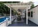 Covered back deck features a dining table, and views of the pool and backyard at 813 Faulkner Pl, Raleigh, NC 27609