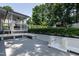 Outdoor patio with white brick grill and built in bench surrounded by greenery at 813 Faulkner Pl, Raleigh, NC 27609