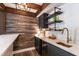 Elegant bar area features wood accents, open shelving, and copper sink at 813 Faulkner Pl, Raleigh, NC 27609