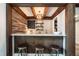 Rustic bar area with wood beams, a white quartz countertop, and barstool seating at 813 Faulkner Pl, Raleigh, NC 27609