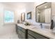 Modern bathroom with double vanity, quartz countertops, stylish mirrors, and a large window for natural light at 813 Faulkner Pl, Raleigh, NC 27609
