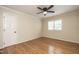 Bright, empty bedroom with hardwood floors, shuttered windows, and a paneled door at 813 Faulkner Pl, Raleigh, NC 27609