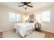 Cozy bedroom with neutral tones, ceiling fan, shuttered windows, and decorative rug at 813 Faulkner Pl, Raleigh, NC 27609
