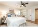 Well-lit bedroom features a ceiling fan, shuttered windows, built in shelves and hardwood floors at 813 Faulkner Pl, Raleigh, NC 27609