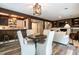 Entertaining space with dining area and bar featuring updated lighting and hardwood floors at 813 Faulkner Pl, Raleigh, NC 27609