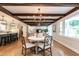 Open-concept dining area flowing into kitchen, featuring wood floors and modern decor at 813 Faulkner Pl, Raleigh, NC 27609
