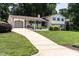 Beautiful home with a long driveway, attached garage, and lovely front yard landscaping at 813 Faulkner Pl, Raleigh, NC 27609