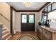 Elegant foyer with wood floors, double doors, staircase, and stylish decor at 813 Faulkner Pl, Raleigh, NC 27609